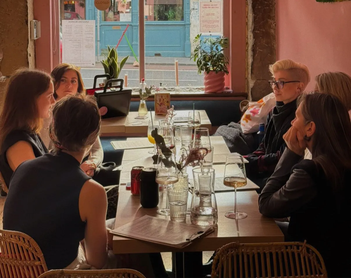Women gathered around a long table at an Original Love Club gathering